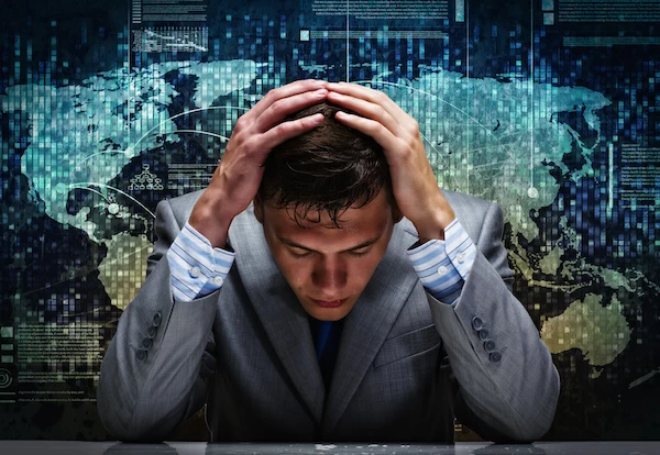Man with hands on head in frustration